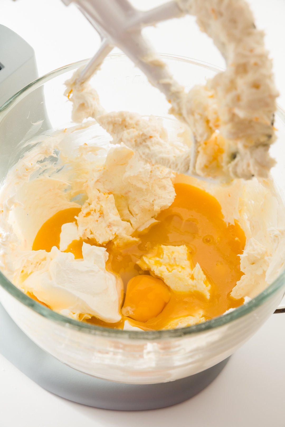Mixing orange concentrate and sour cream into cheesecake batter