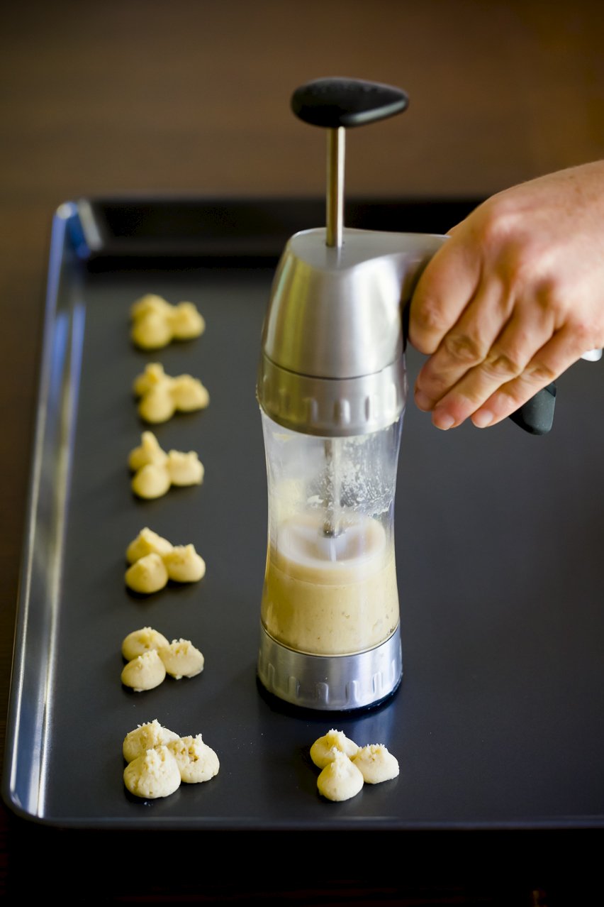 Wilton Cookie Press pressing onto the cookie sheet