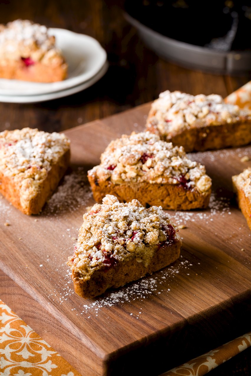 Scones with crumb topping on a wood cutting board