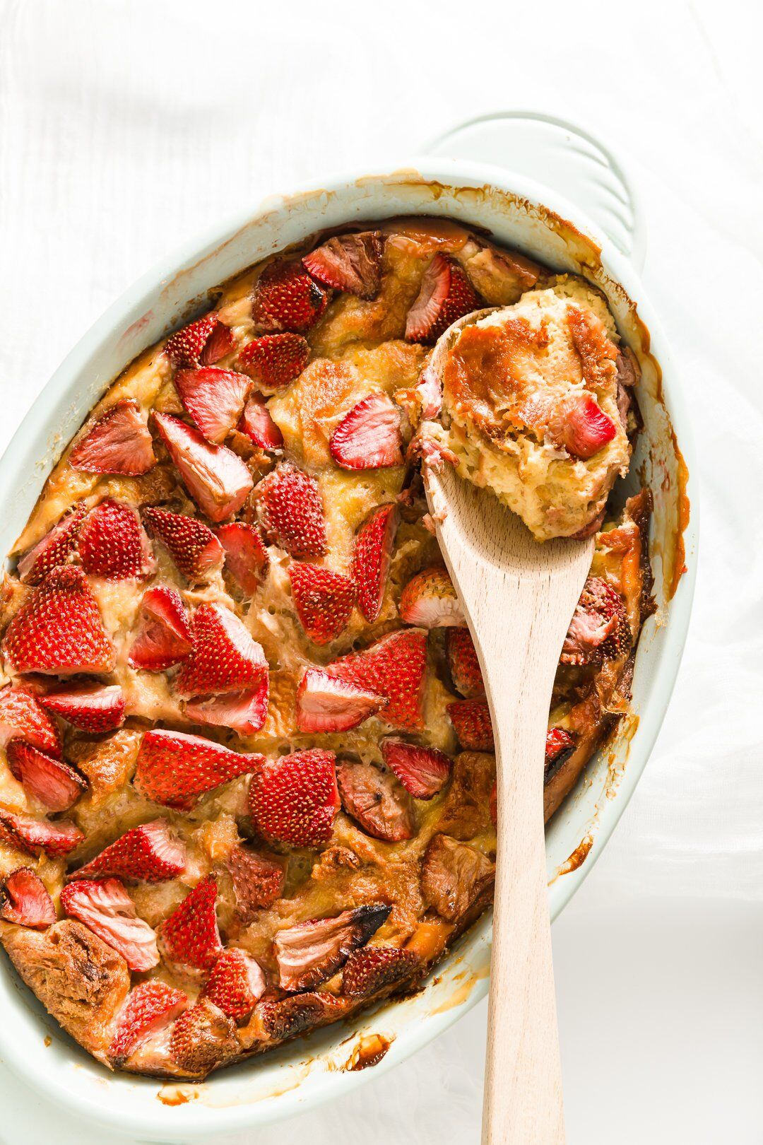 Brioche French toast in casserole dish with a scoop taken out