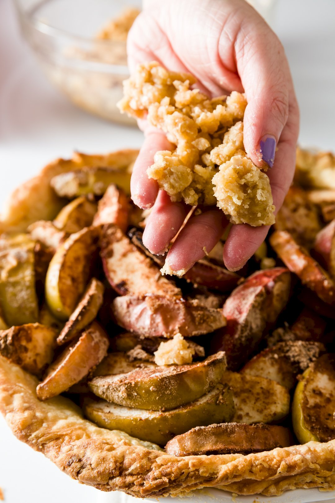 adding crumb topping for apple pie