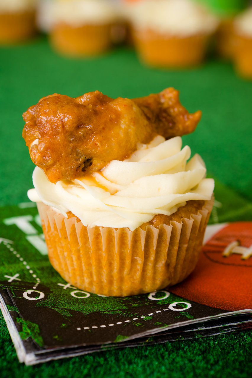 Buffalo chicken cupcake on a Super Bowl napkin with a buffalo chicken wing on top