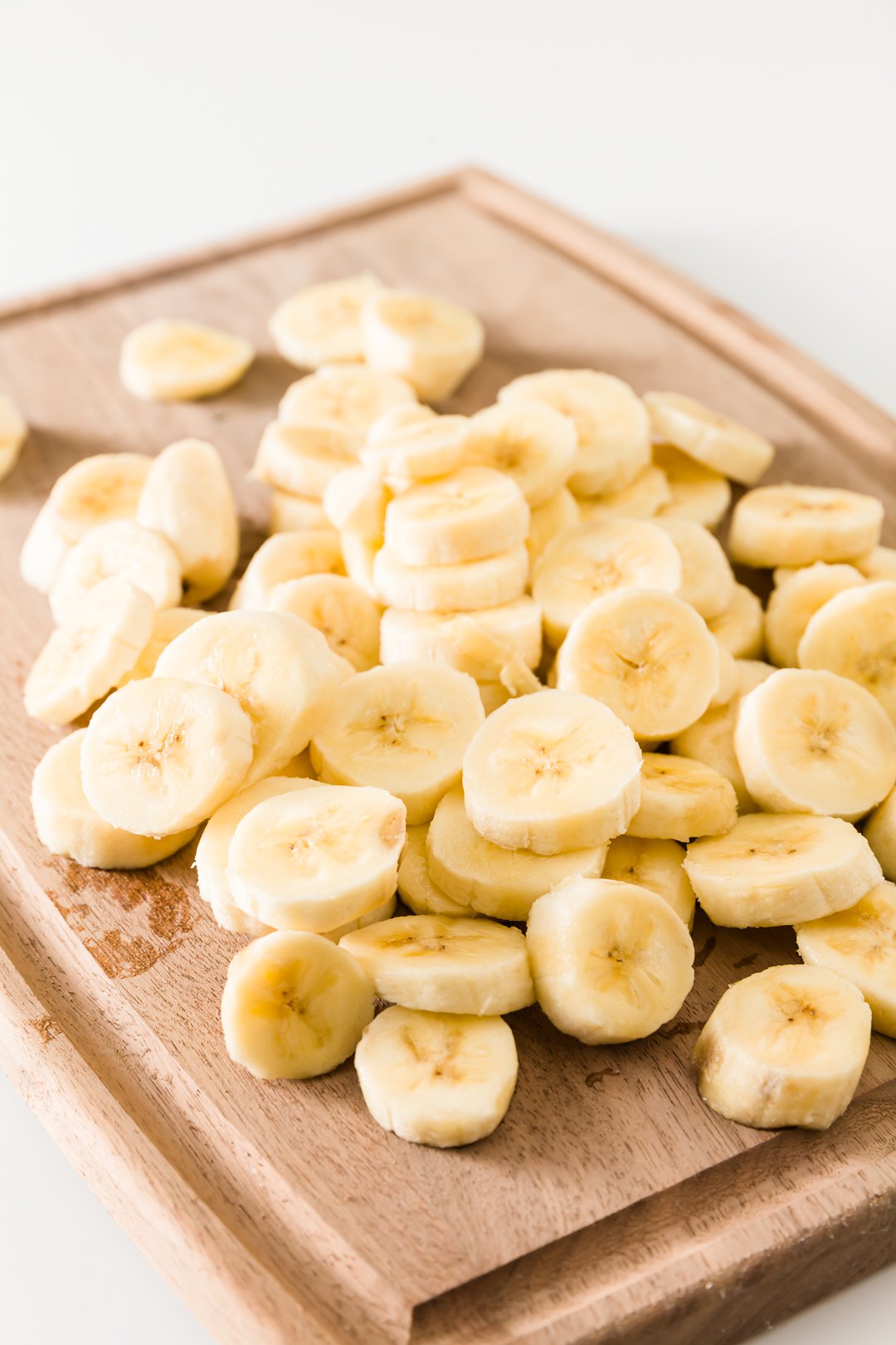 A board filled with chopped bananas