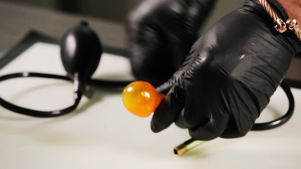 Blood pressure pump curled around with isomalt globe next to it