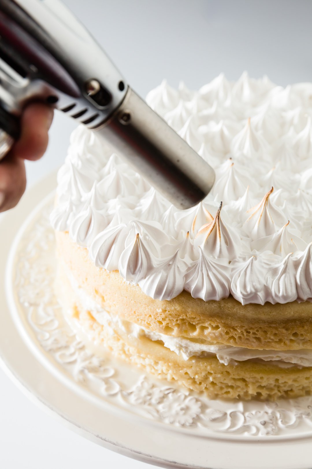 Using a culinary torch to toast meringue frosting