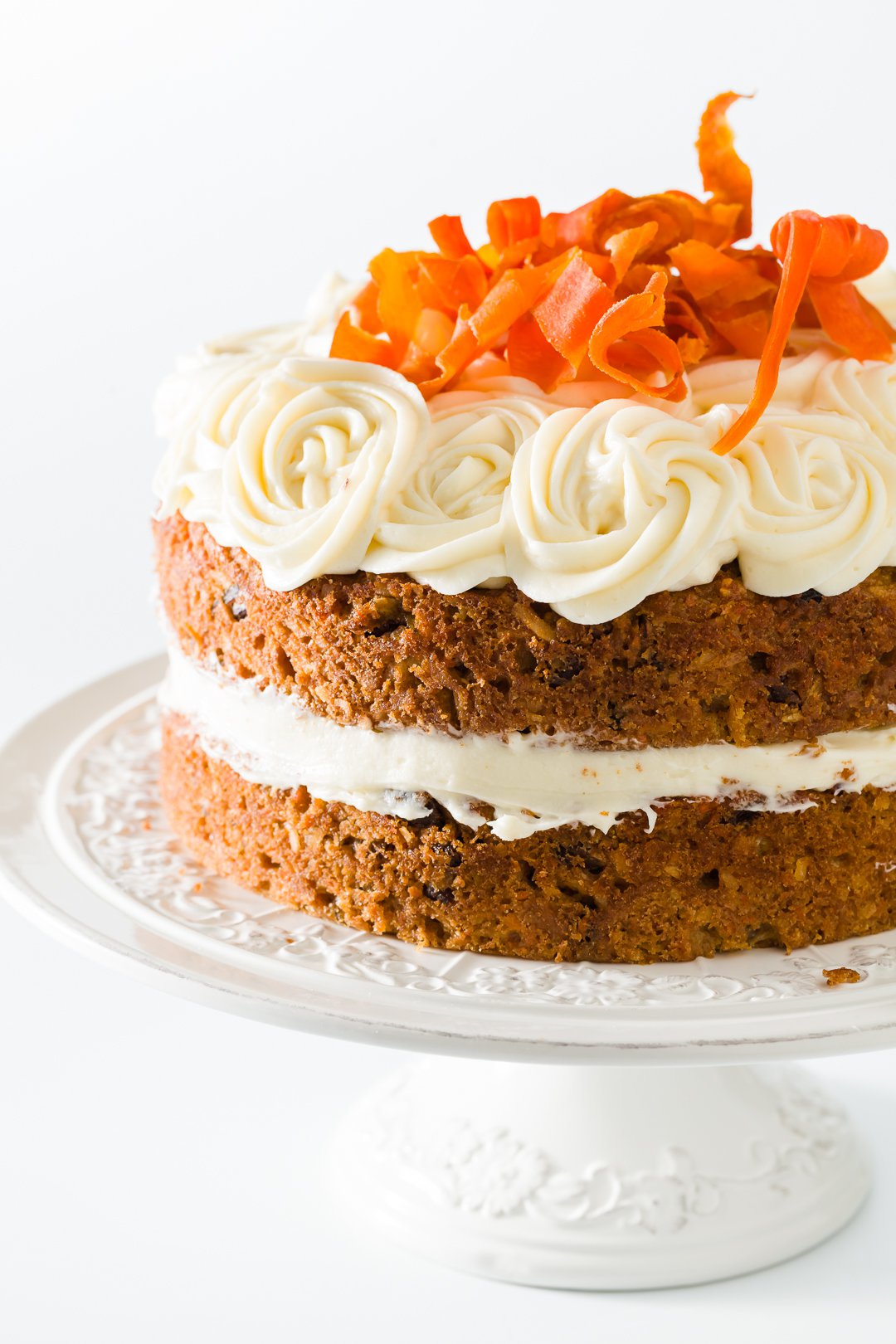 Two layer carrot cake on a cake stand