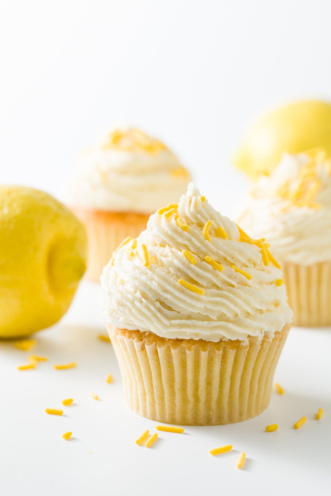 Several lemon cupcakes decorated with lemon buttercream frosting