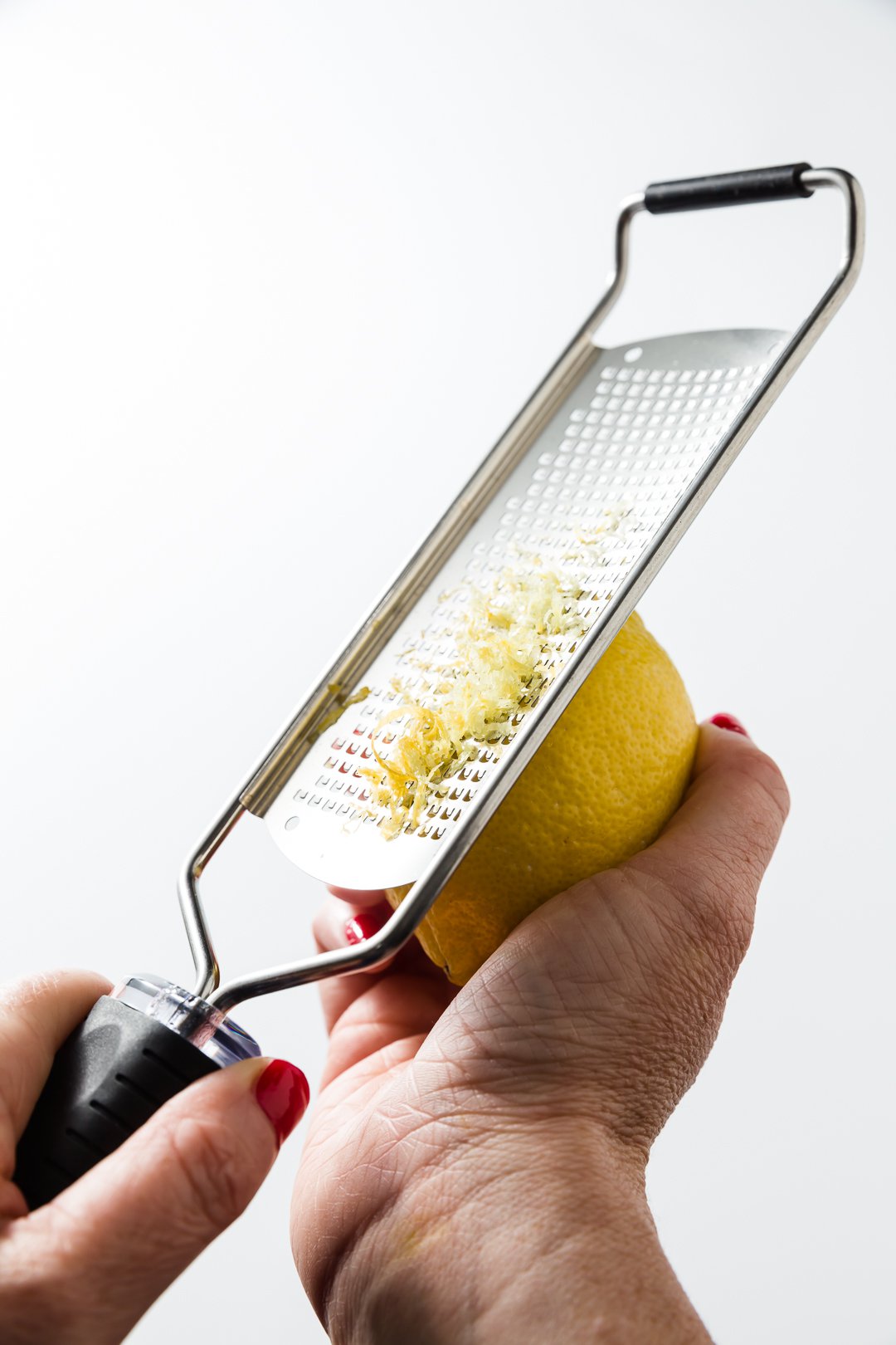 Zesting a lemon with a microplane