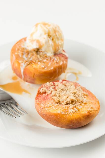 Baked Peaches with crumb topping and ice cream