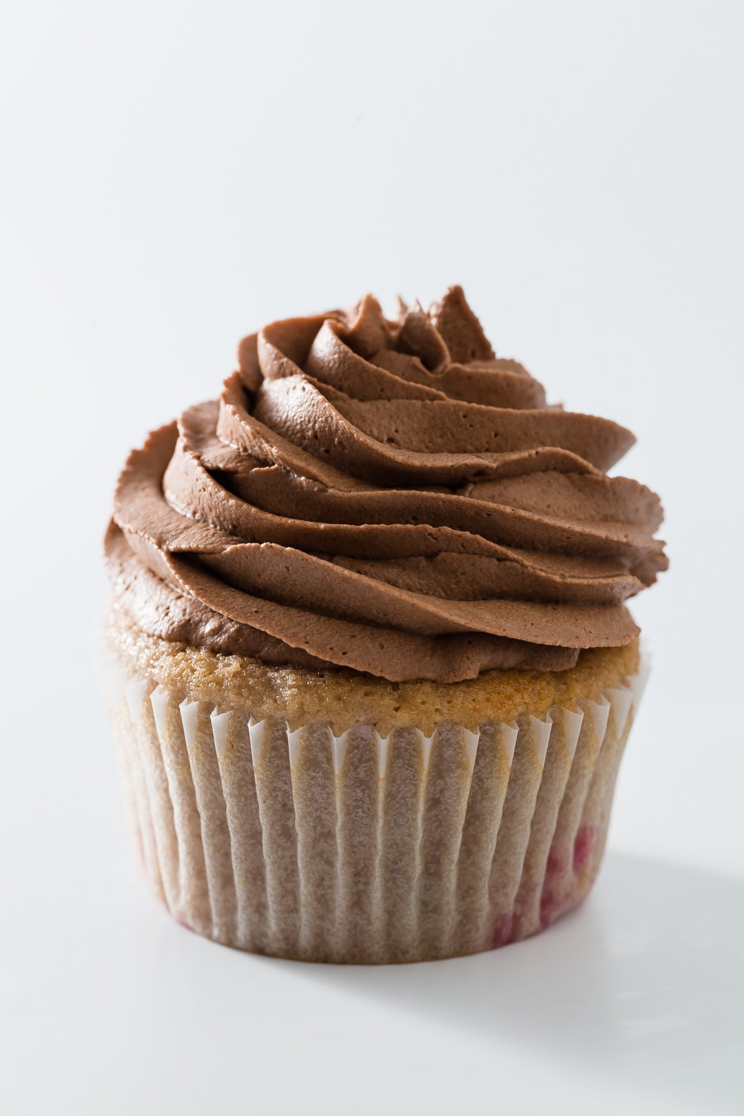 Chocolate whipped cream on cupcake