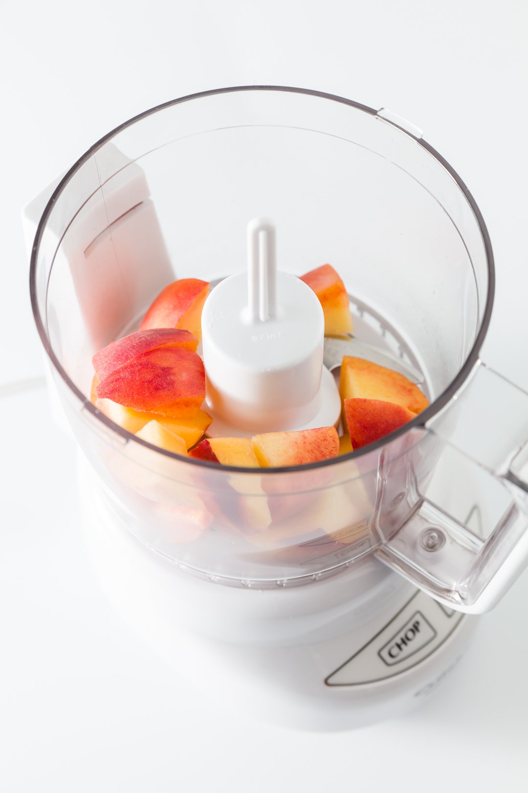 Chunks of peaches in a food processor