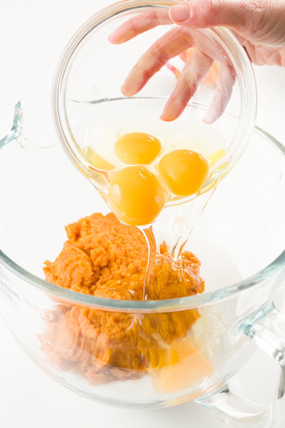Adding eggs to pumpkin puree