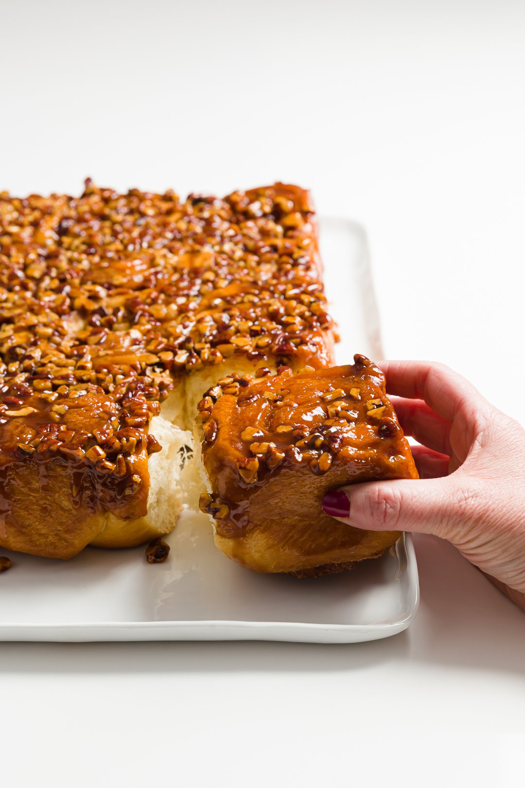 A tray of honey buns with one pulled out