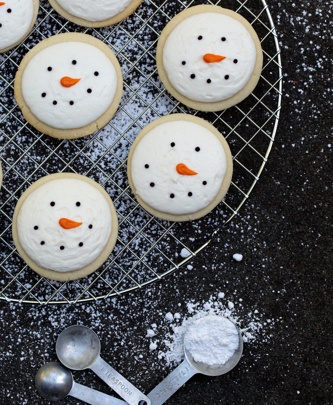 Snowman cookies on a cooling rack