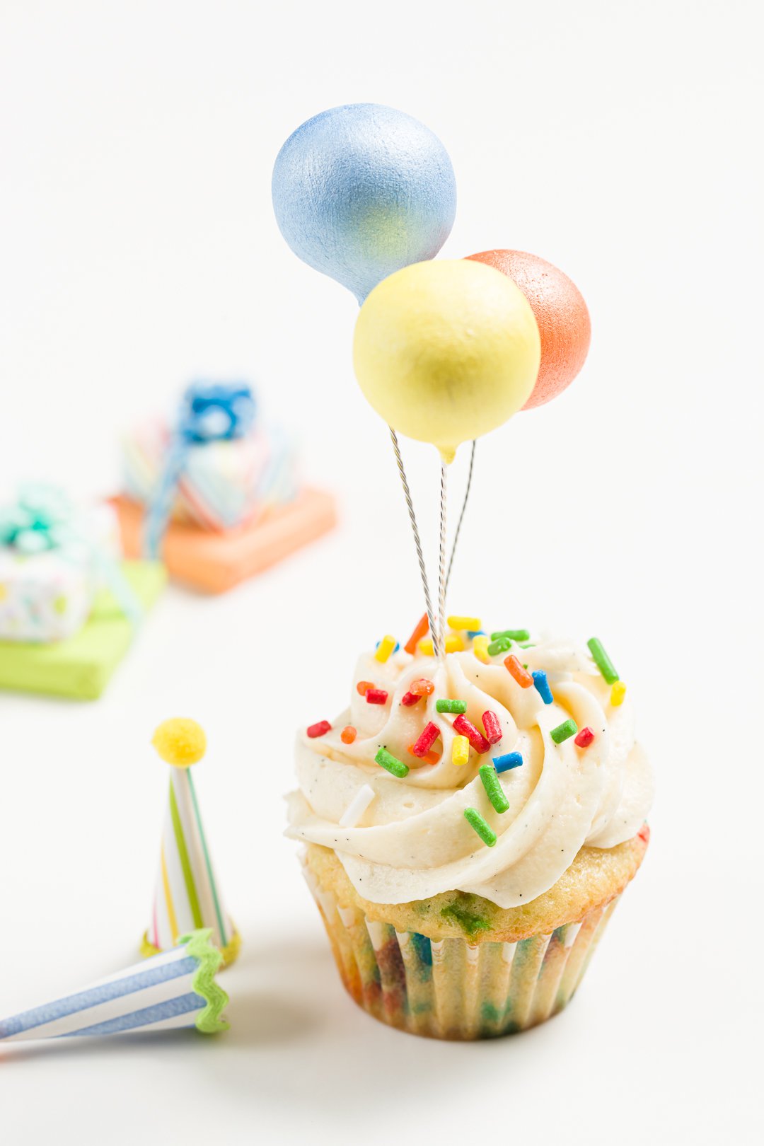 Birthday cupcake topped with balloons