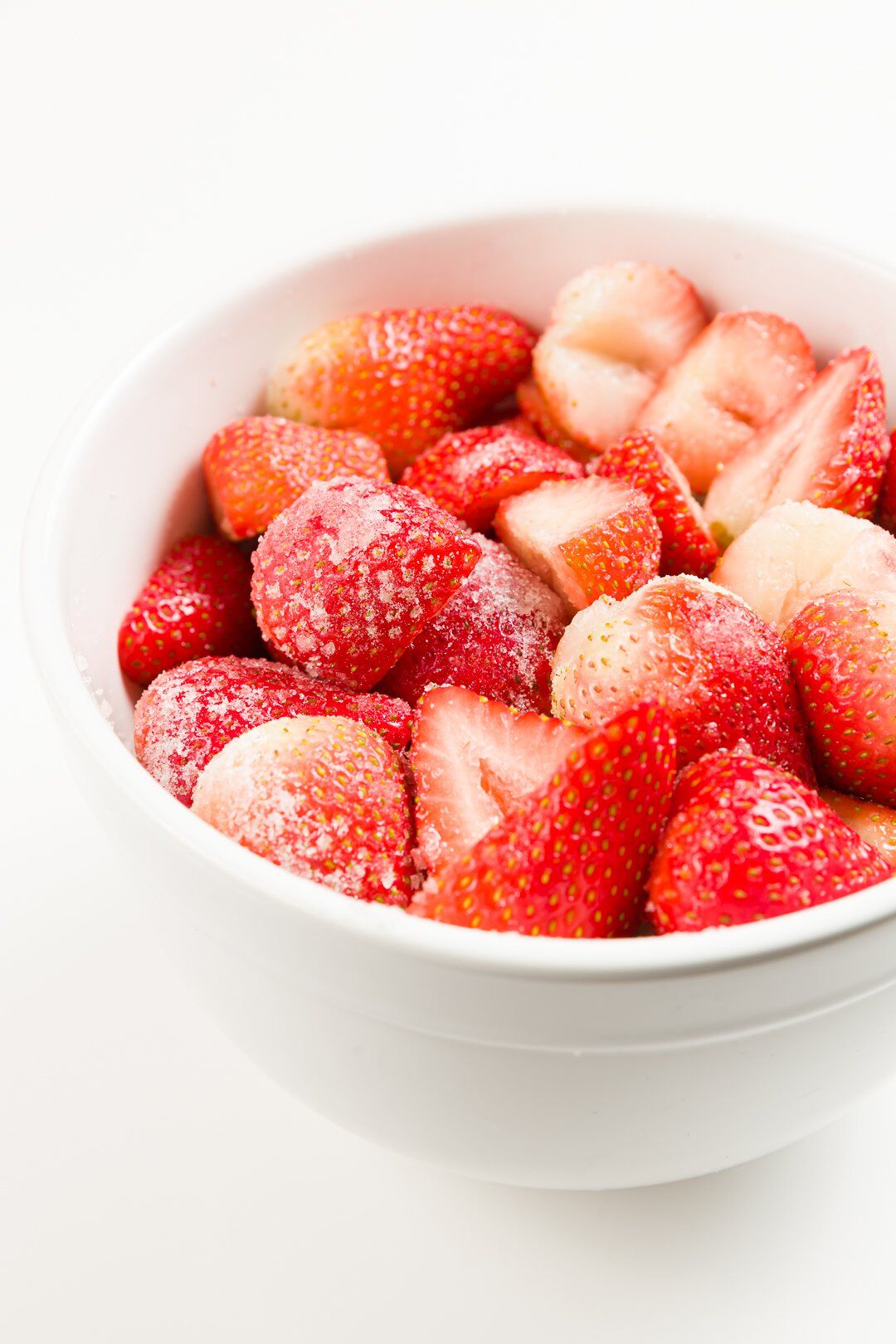 A large bowl of strawberries coated with sugar