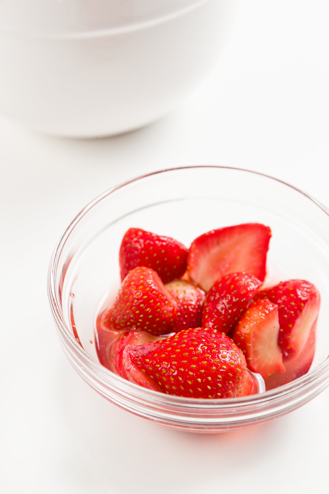 A bowl of glistening macerated strawberries