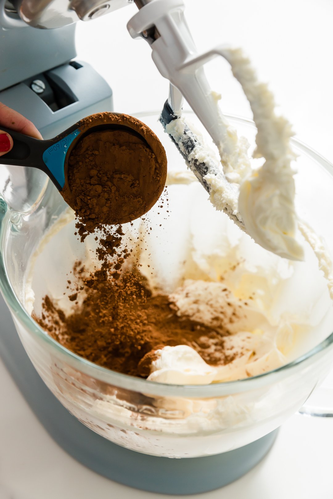 Adding cocoa powder to frosting