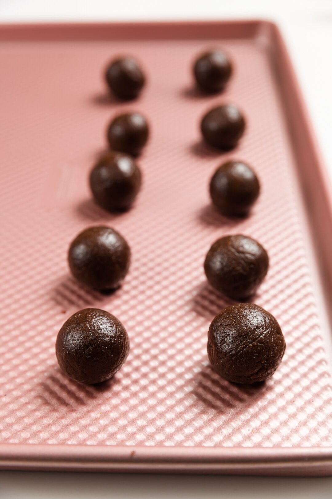Undipped cake truffles on a cookie sheet