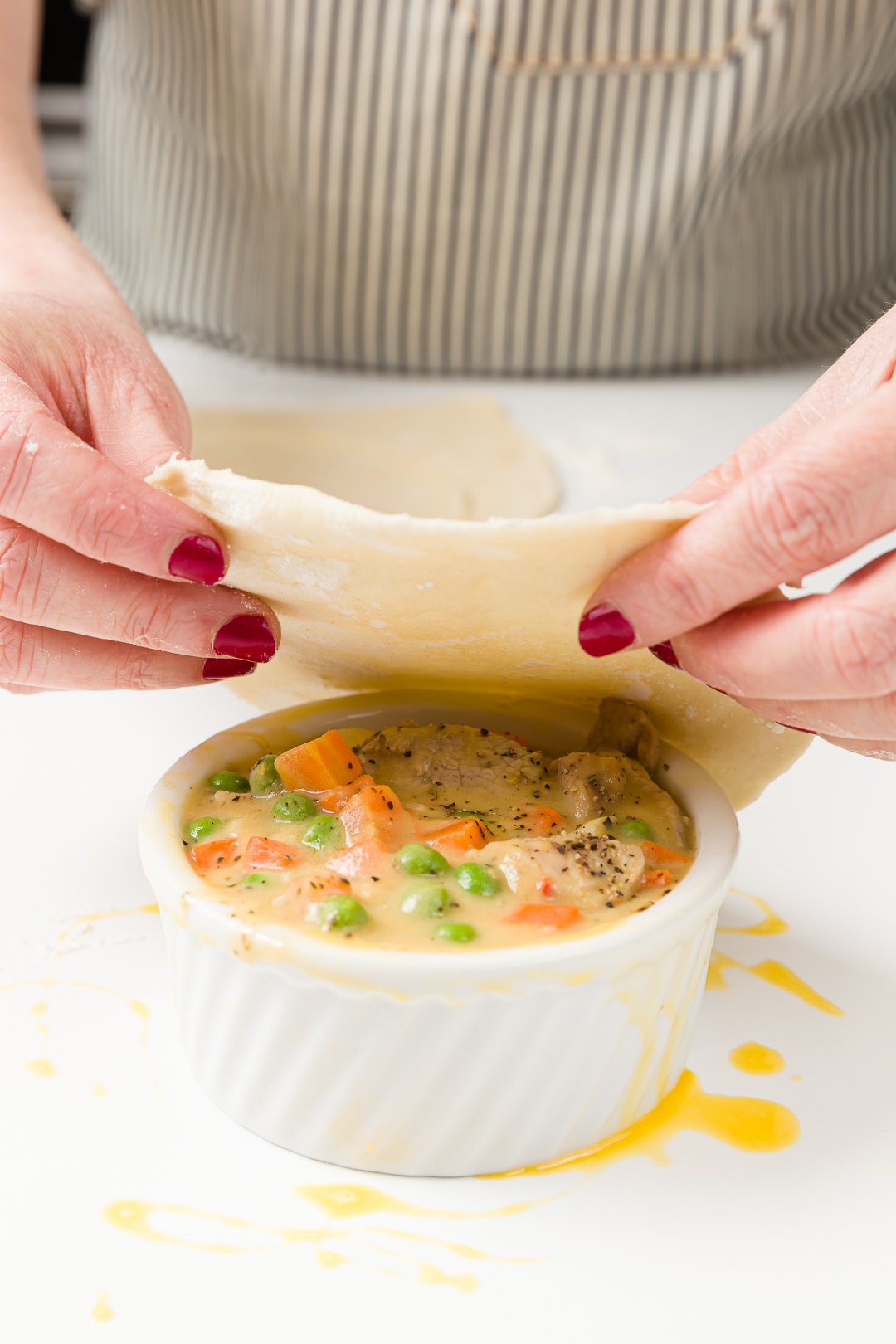 Putting puff pastry over a ramekin