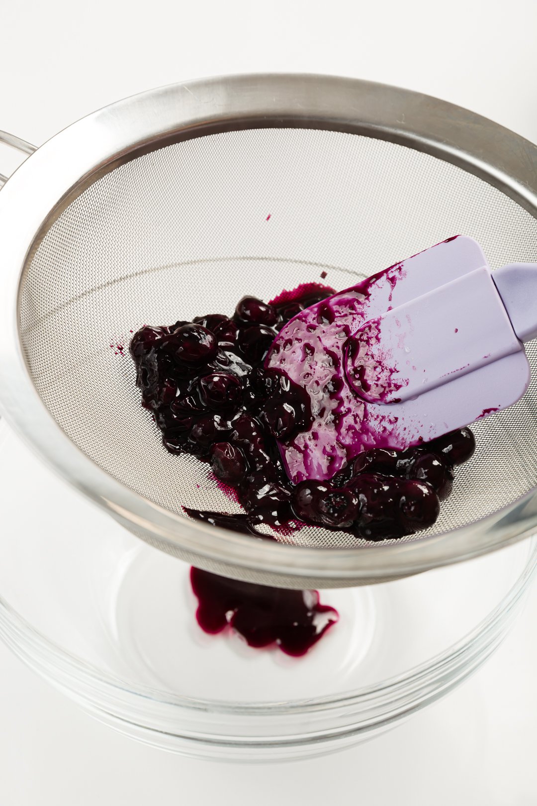 Blueberry sauce in a sieve