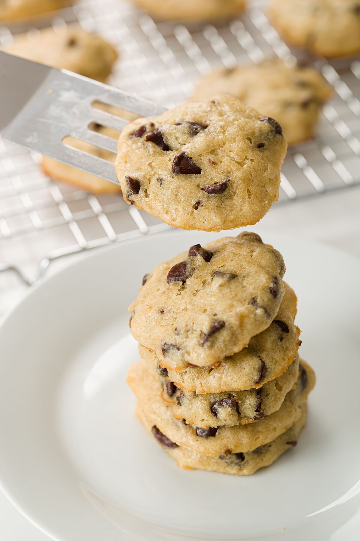 Adding a cookie to a stack of cookies using a spatula