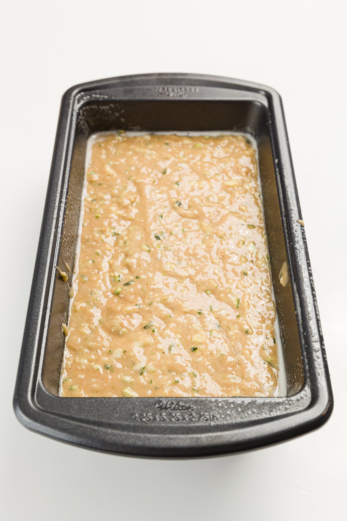 Zucchini Bread batter in a metal loaf pan