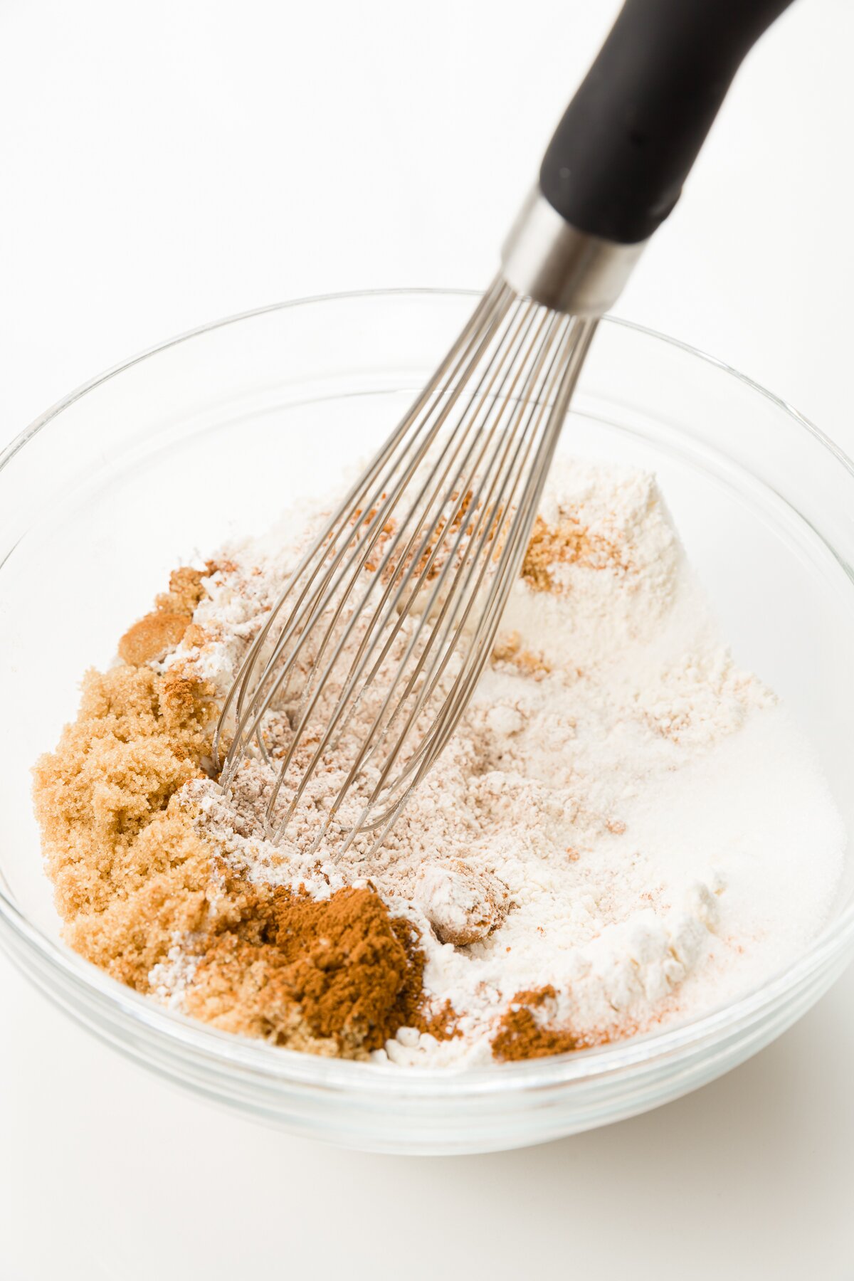whisking dry ingredients in a glass bowl