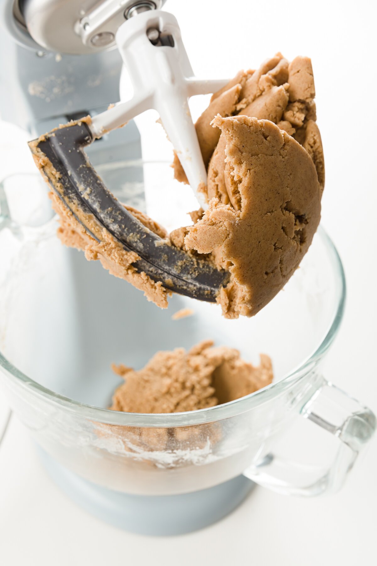 speculoos cookie dough stuck to the blade of an electric mixer