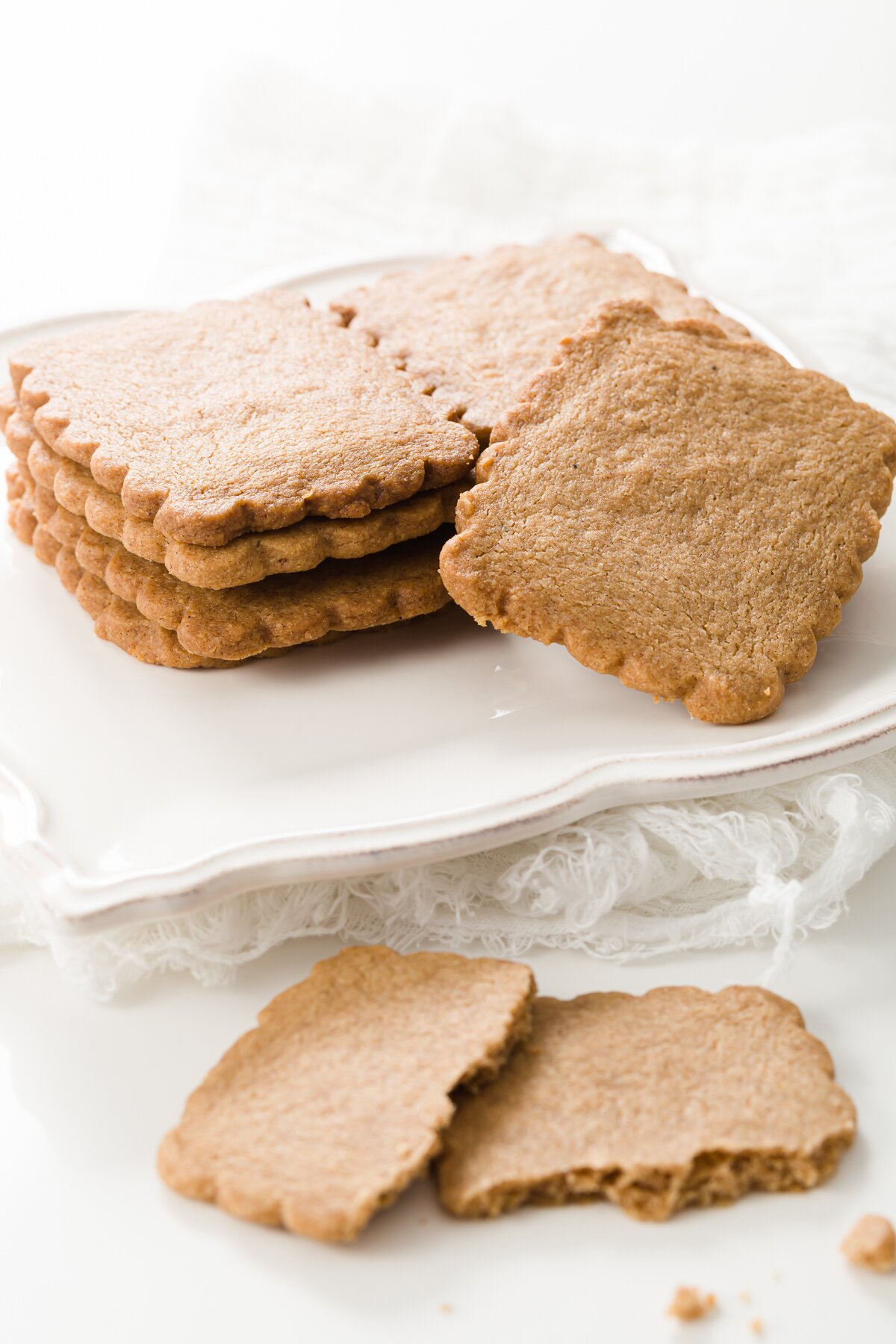 a pile of speculoos cookies on a white plate