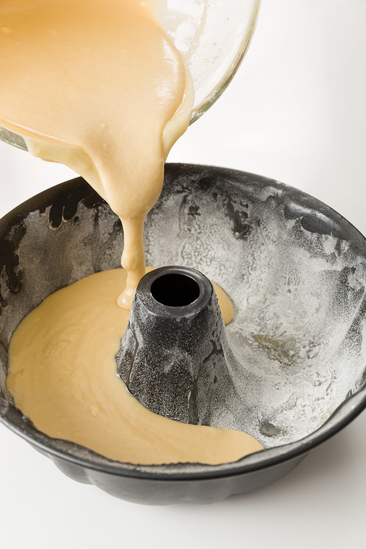 tight shot of Stef pouring batter into a Bundt pan