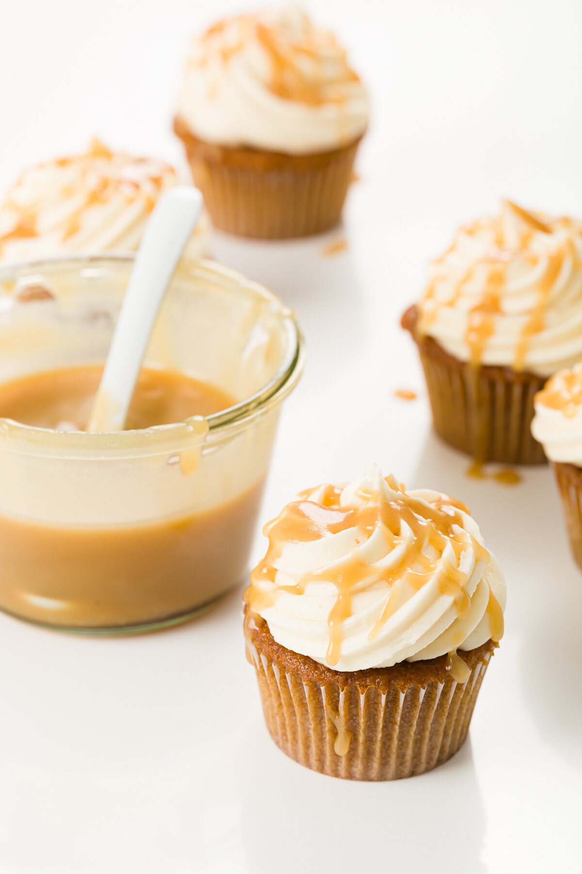 Butterscotch cupcakes with a jar of butterscotch sauce