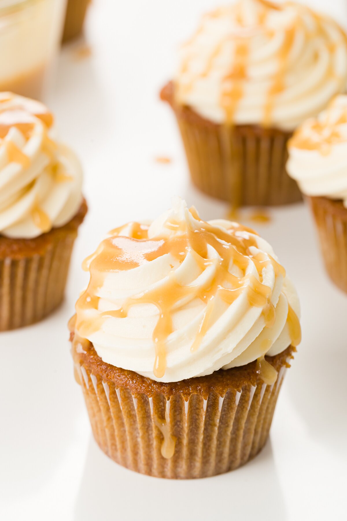 A group of butterscotch cupcakes with one in the front