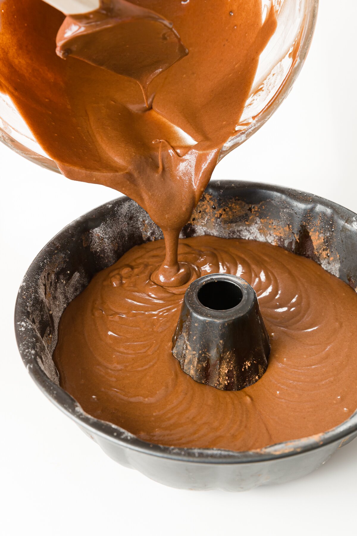 Pouring chocolate cake batter into Bundt pan