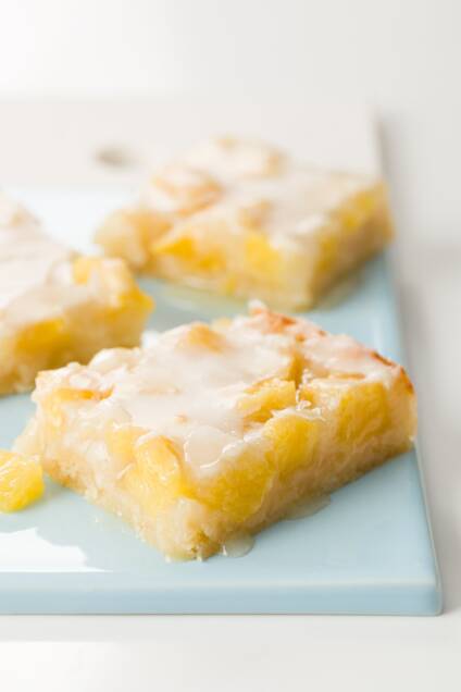 A few pineapple bars on a blue serving plate