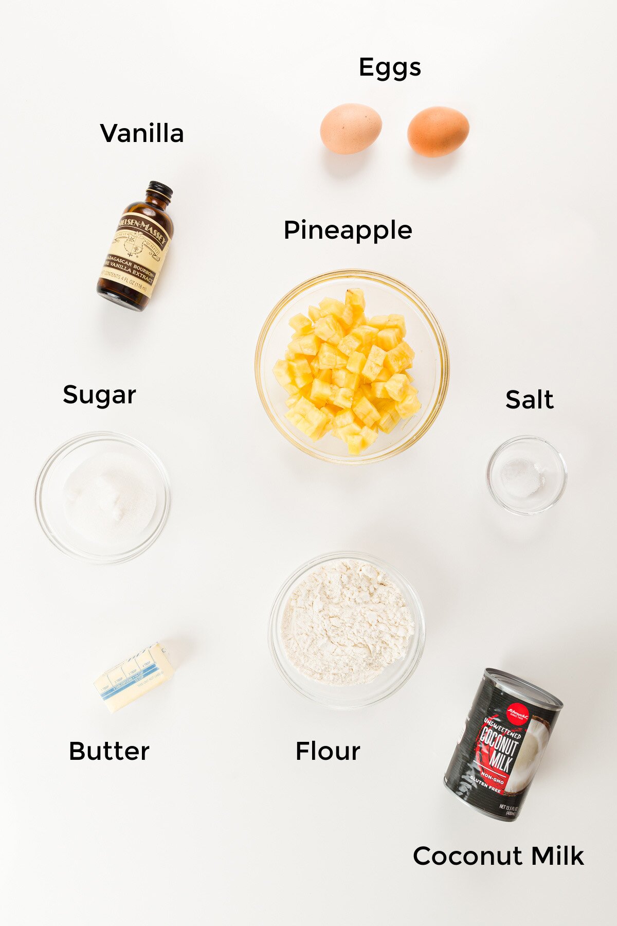 overhead view of ingredients in pineapple bars - vanilla, eggs, pineapple, sugar, salt, butter, flour, and coconut milk