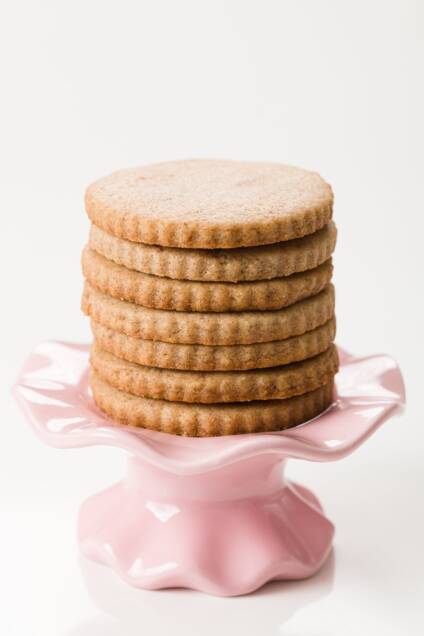 stack of cinnamon sugar cookies on a small pink stand