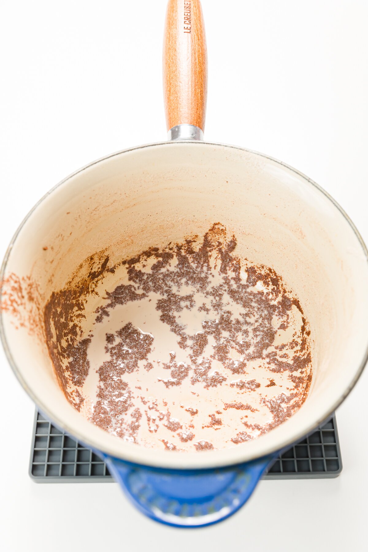 Looking down into a sauce pan with cinnamon sludge on the bottom of it