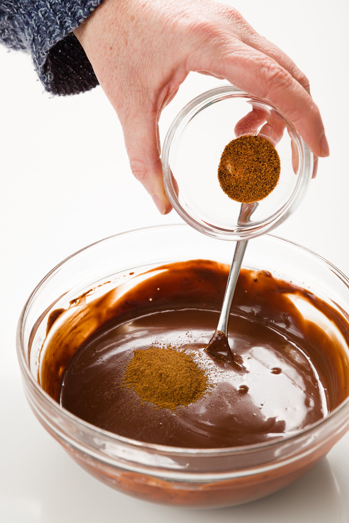 Adding cayane pepper to chocolate sauce