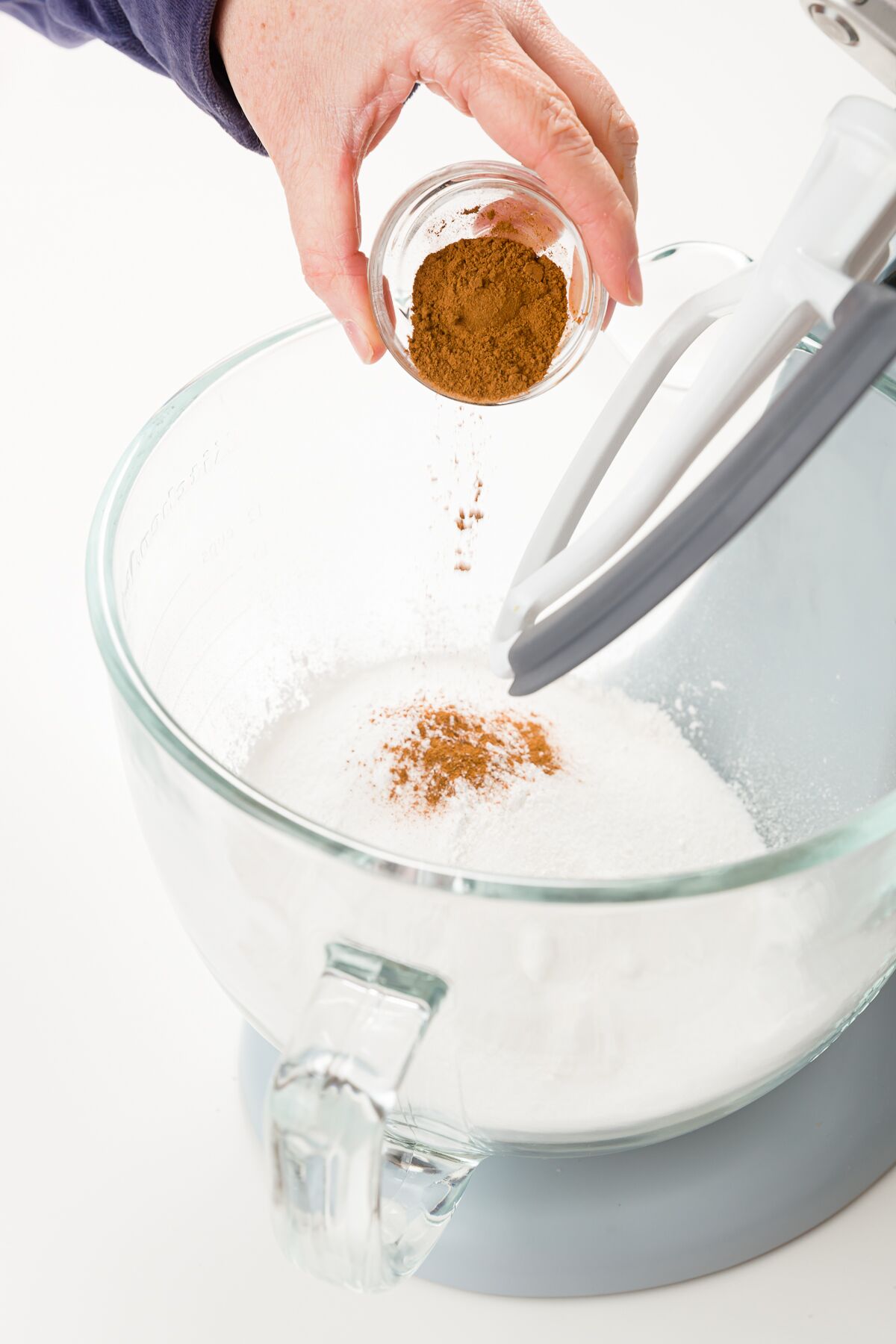 Adding cinnamon to dry ingredients in stand mixer