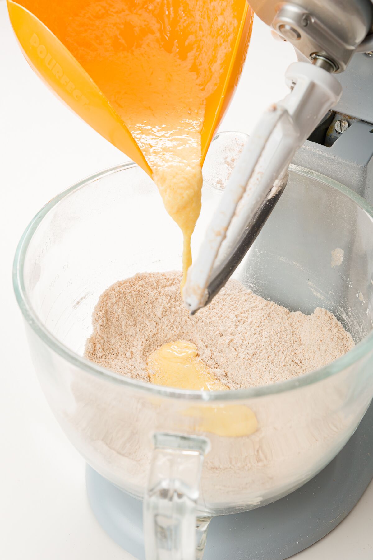 Pouring wet ingredients into stand mixer