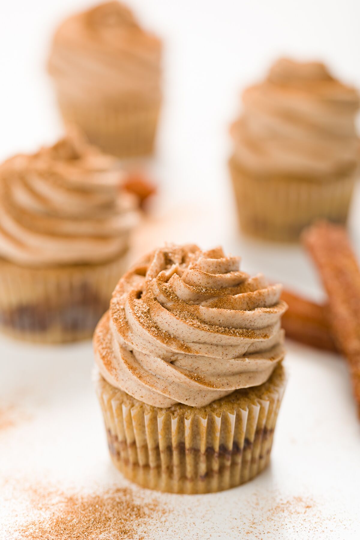 Grouping of churro cupcakes with churros in the background