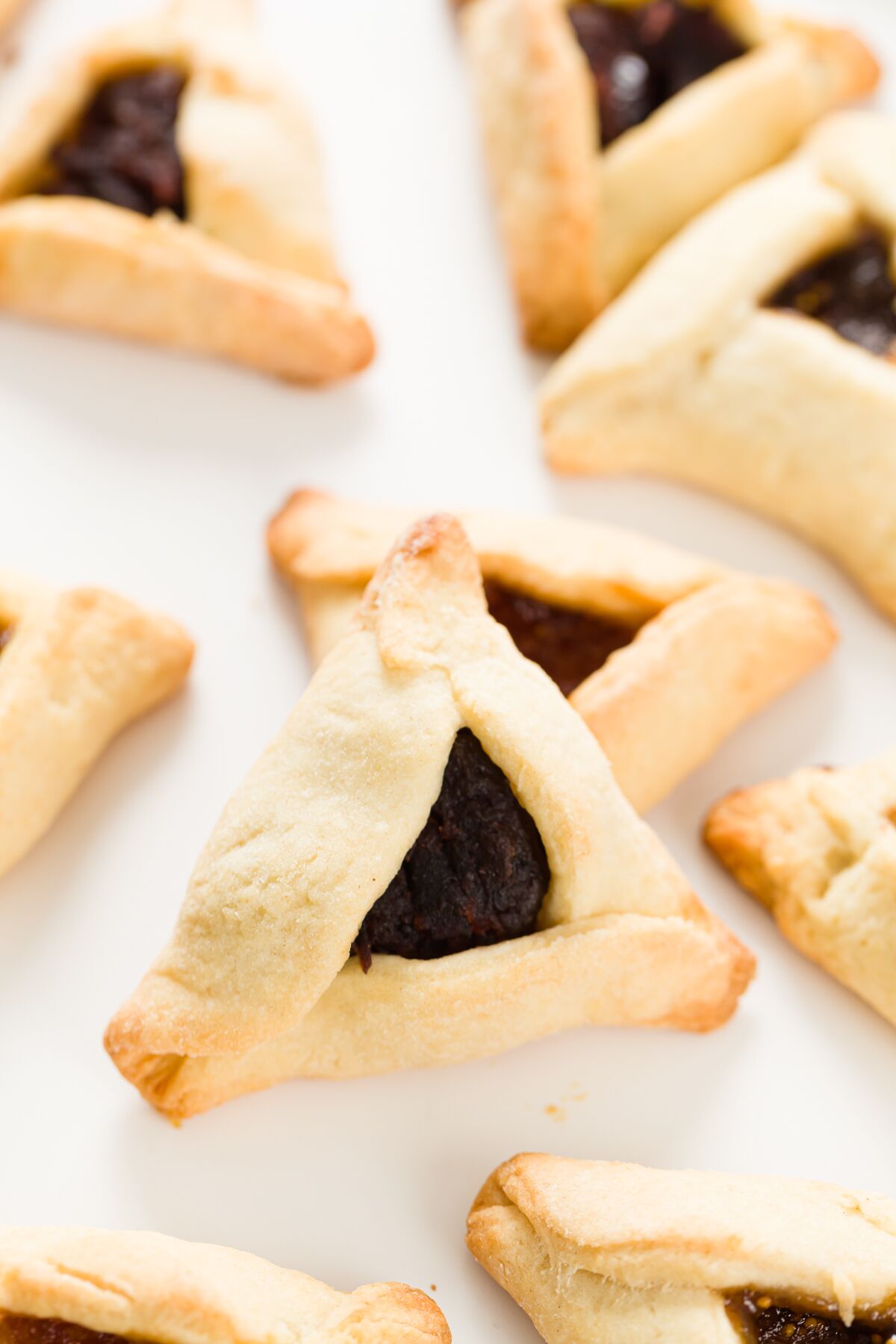 Looking down on a grouping of Hamantaschen with a variety of fillings