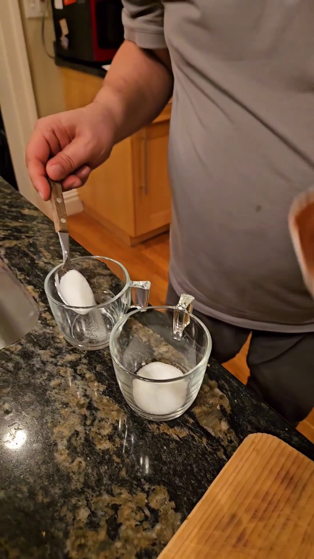 Adding sugar to glass cups.
