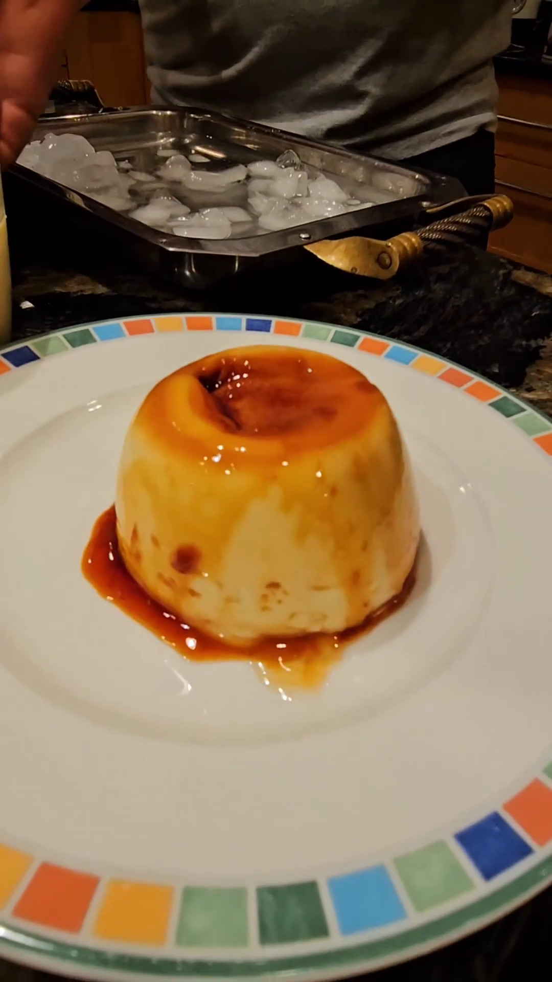 A finished microwave flan turned upside down on a plate.