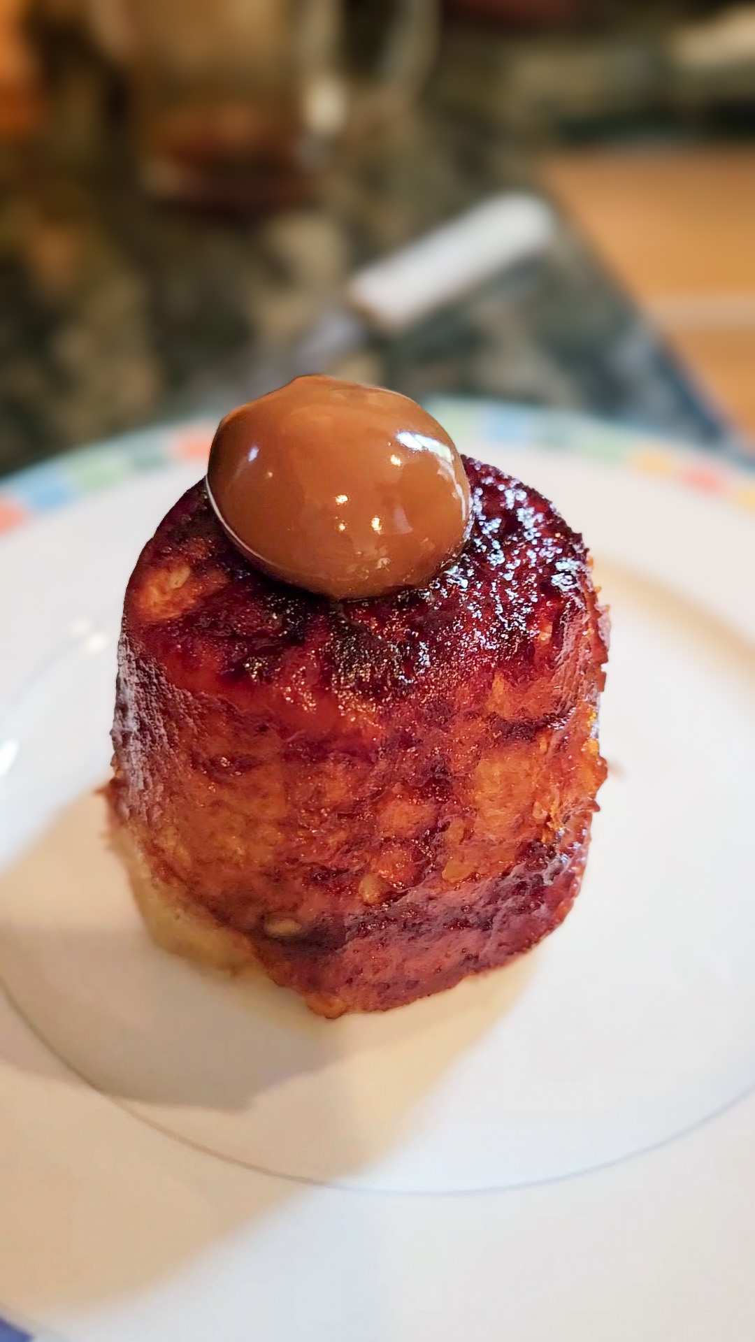 Finished microwave banana bread on a plate with a scoop of dulce de leche.