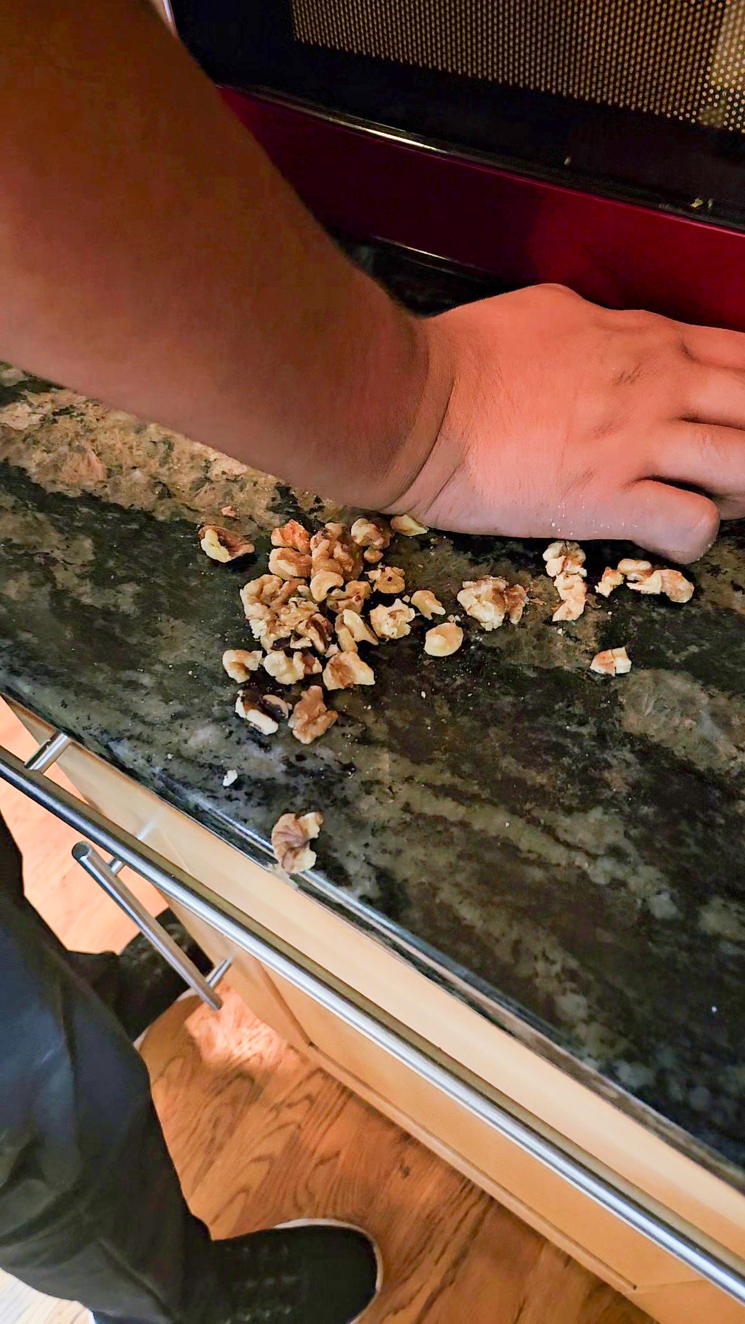 Crushing walnuts on a clean countertop.